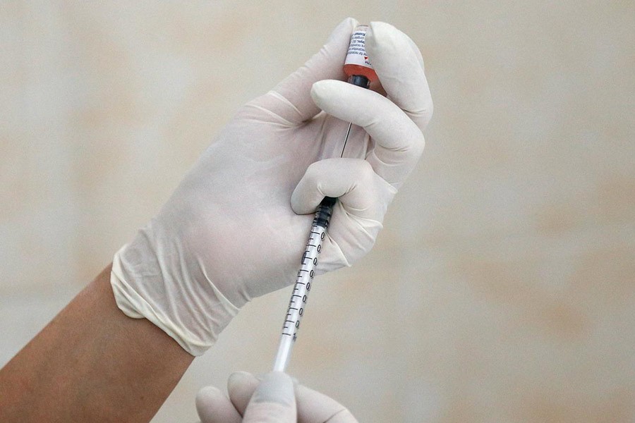 A nurse filling a syringe with a vaccine before administering an injection at a children's clinic in Kiev, Ukraine in August this year. -Reuters file photo