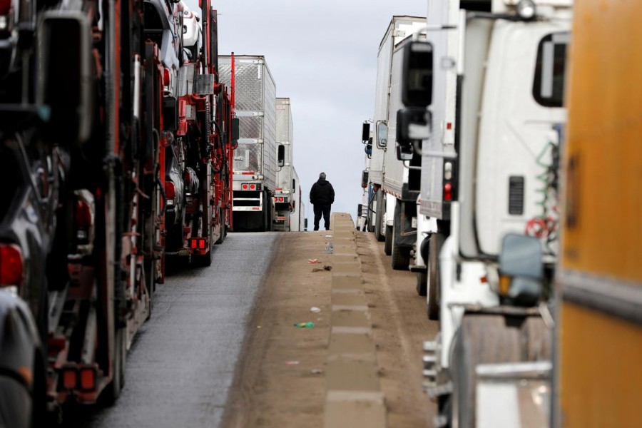 A man stands between trucks waiting in a long queue at border customs control to cross into the US at the Otay border crossing in Tijuana, Mexico, April 3, 2019. Reuters/Files