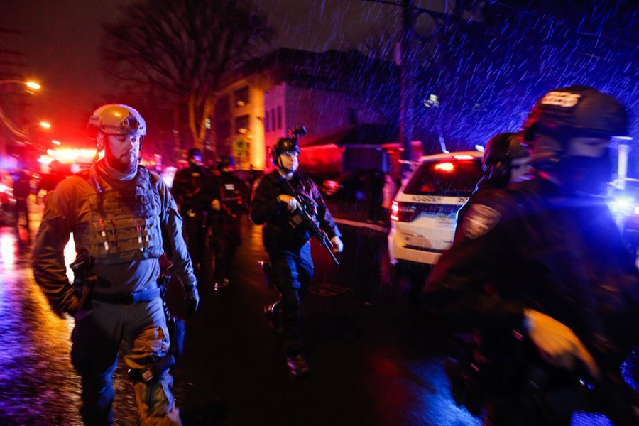 Law enforcement personnel walk near the scene following a shooting on Tuesday, December 10, 2019, in Jersey City, NJ — AP photo