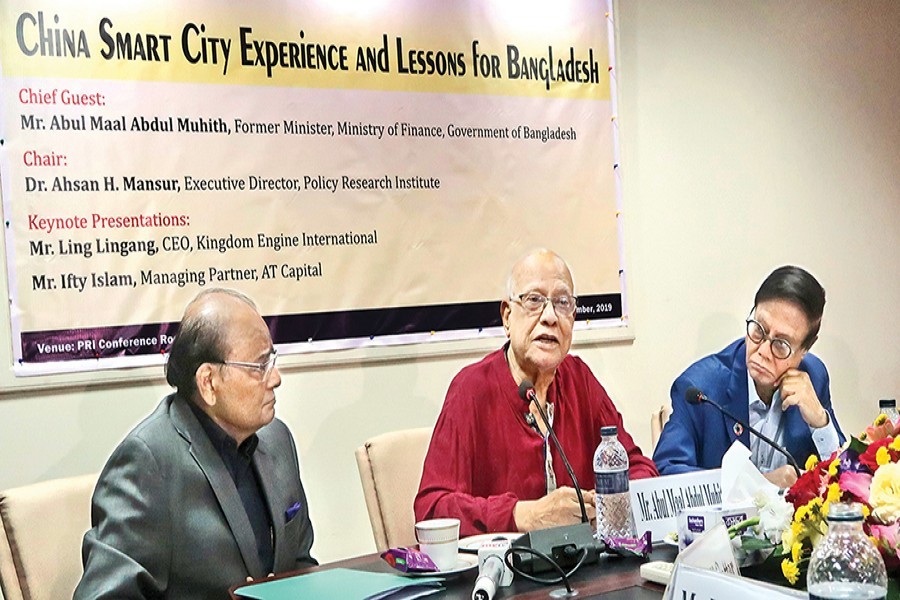 Former Finance Minister A M A Muhith (centre) speaking at a seminar on 'China Smart City Experience and Lessons for Bangladesh' at the conference room of PRI in the city on Wednesday. PRI Chairman Dr Zaidi Sattar (left) and PRI Executive Director Dr Ahsan H Mansur (right) also spoke at the seminar — FE photo