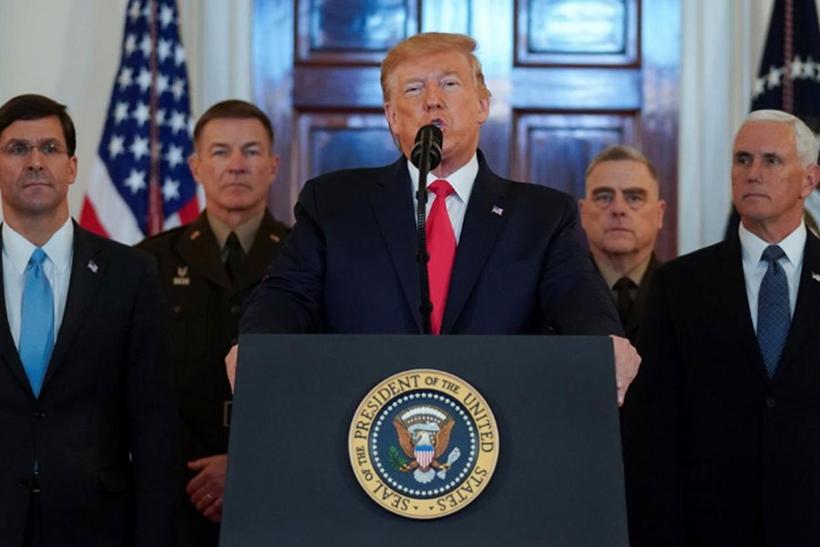 US President Donald Trump delivering a statement about Iran flanked by US Secretary of Defence Mark Esper, Vice President Mike Pence and military leaders in the Grand Foyer at the White House in Washington on Wednesday. -Reuters Photo