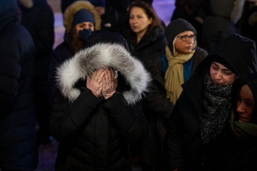 A woman mourns outside the Alberta Legislature Building in Edmonton, Alberta, Wednesday, January 8, 2020, during a vigil for those killed after a Ukrainian passenger jet crashed, killing at least 63 Canadians, just minutes after taking off from Iran's capital — Codie McLachlan/The Canadian Press via AP