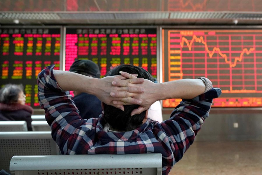 An investor looks at a stock quotation board at a brokerage office in Beijing, China, January 03, 2020. Reuters/Files