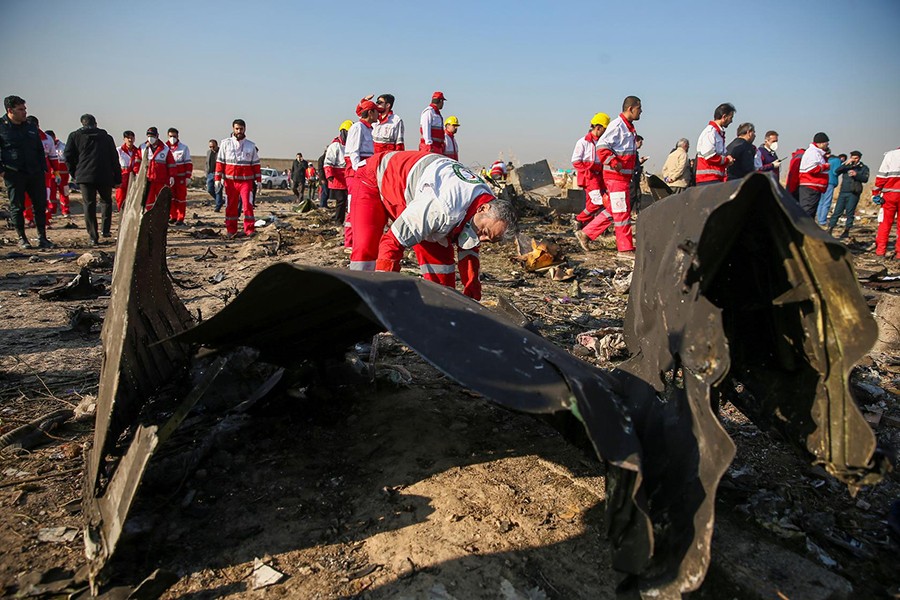 Red Crescent workers check the debris from the Ukraine International Airlines plane, that crashed after take-off from Iran's Imam Khomeini airport, on the outskirts of Tehran, Iran on January 8, 2020 — West Asia News Agency via Reuters