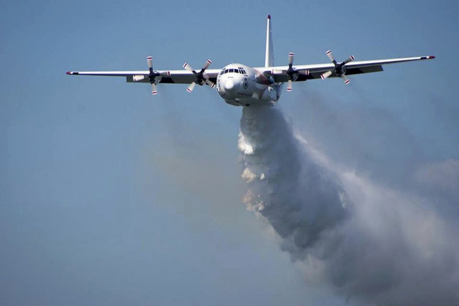 In this undated photo released from the Rural Fire Service, a C-130 Hercules plane called 'Thor' drops water during a flight in Australia. Picture used only for representation —  RFS via AP