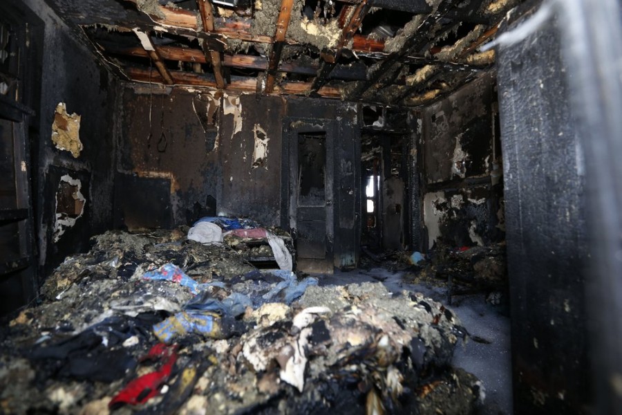 Burned clothes and the interior of a house are destroyed from a fatal fire on Saturday, Feb. 8, 2020 in Clinton, Mississippi, (AP Photo/Rogelio V. Solis)