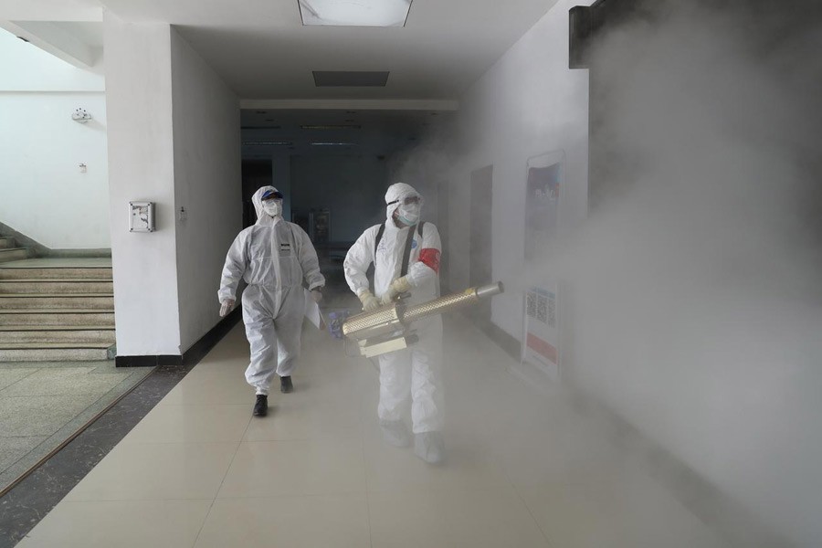 Volunteers in protective suits disinfect a residential compound in Wuhan, the epicentre of the novel coronavirus outbreak, in Hubei province, China, February 22, 2020. China Daily via Reuters