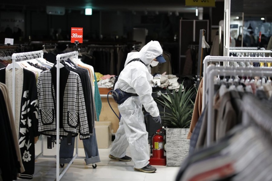 A worker wearing protective gear sprays disinfectant as a precaution against the new coronavirus at a department store in Seoul, South Korea, Monday, March 02, 2020 — AP Photo