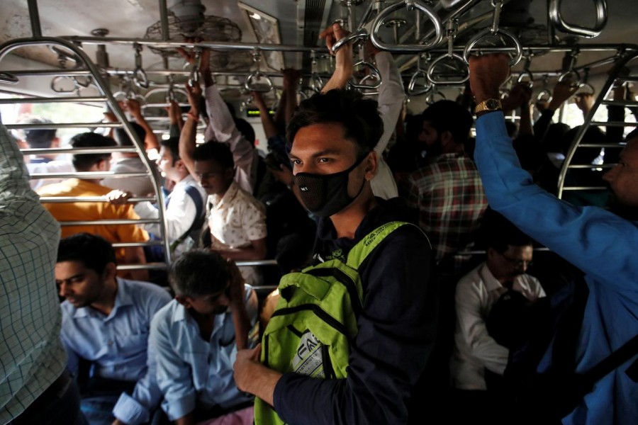 A commuter wearing a protective mask travels in a crowded suburban train during morning rush hour in Mumbai, India on March 6, 2020 — Reuters photo