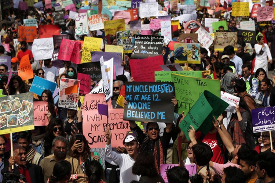 Women and men carry signs as they take part in an Aurat March, or Women's March in Lahore, Pakistan Mar 8, 2020. (Reuters)