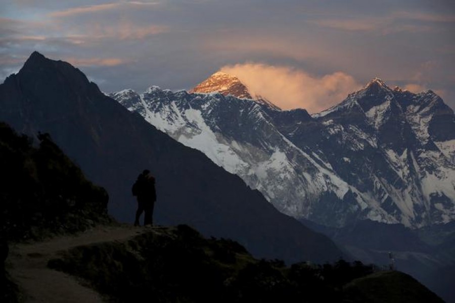 Light illuminates Mount Everest (C) during sunset in Solukhumbu district, also known as the Everest region, in this picture taken on November 30, 2015 — Reuters/Files