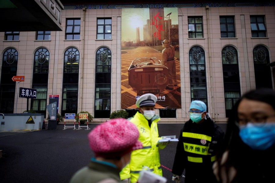 People wearing protective face masks are seen outside a hospital following an outbreak of coronavirus (COVID-19), in downtown Shanghai, China, March 13, 2020. — Reuters/Files