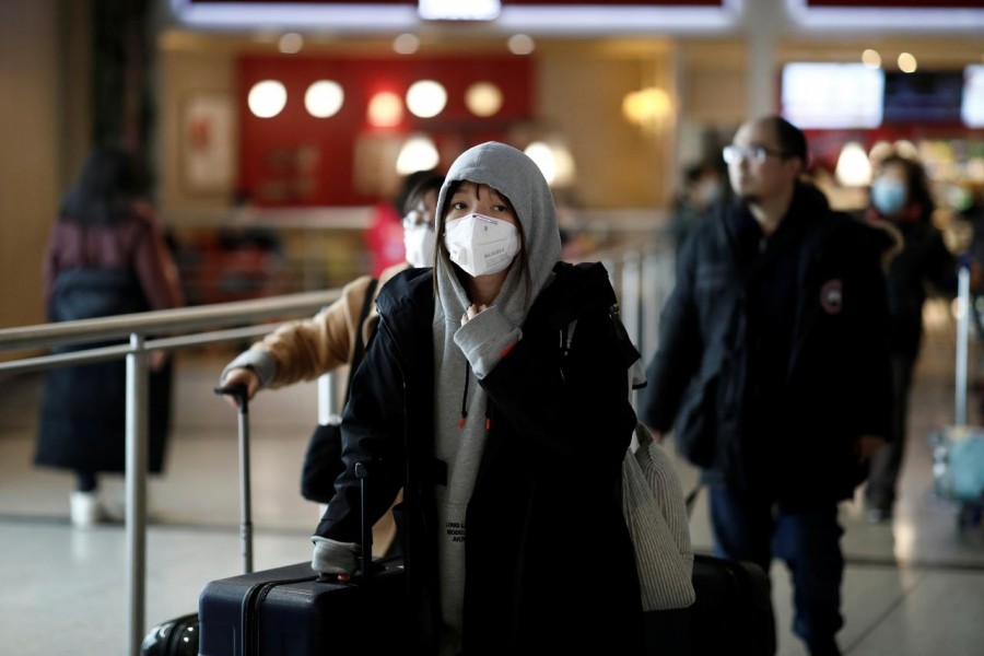 Tourists from an Air China flight from Beijing wear protective masks as they arrive at Charles de Gaulle airport in Paris, France, January 26, 2020. — Reuters/Files