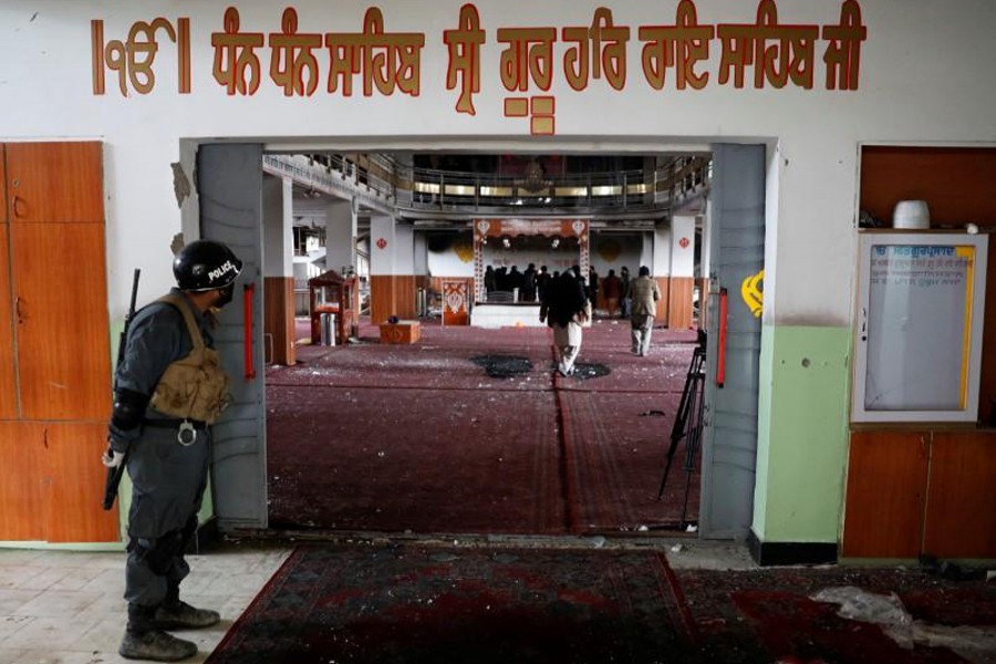 An Afghan policeman inspects inside a Sikh religious complex after an attack in Kabul, Afghanistan on March 25, 2020