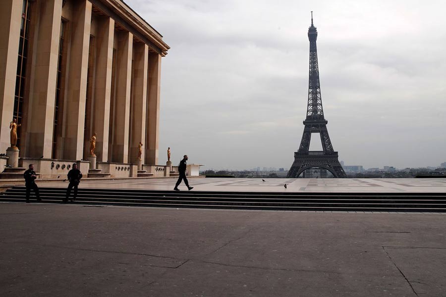 Police officers patrolling the empty Trocadero plaza next to the Eiffel Tower in Paris on March 17 –AP Photo