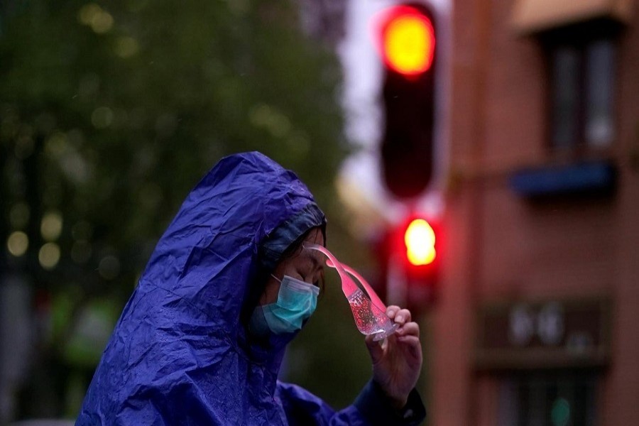 A woman wearing a face mask is seen on a street after the lockdown was lifted in Wuhan, the capital of Hubei province and China's epicentre of the novel coronavirus disease (COVID-19) outbreak, April 10, 2020. – Reuters