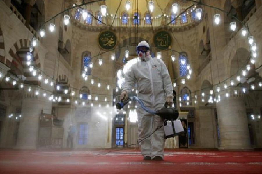A municipality worker in a protective suit disinfects Kilic Ali Pasha Mosque due to coronavirus concerns in Istanbul, Turkey, March 11, 2020. — Reuters/Files