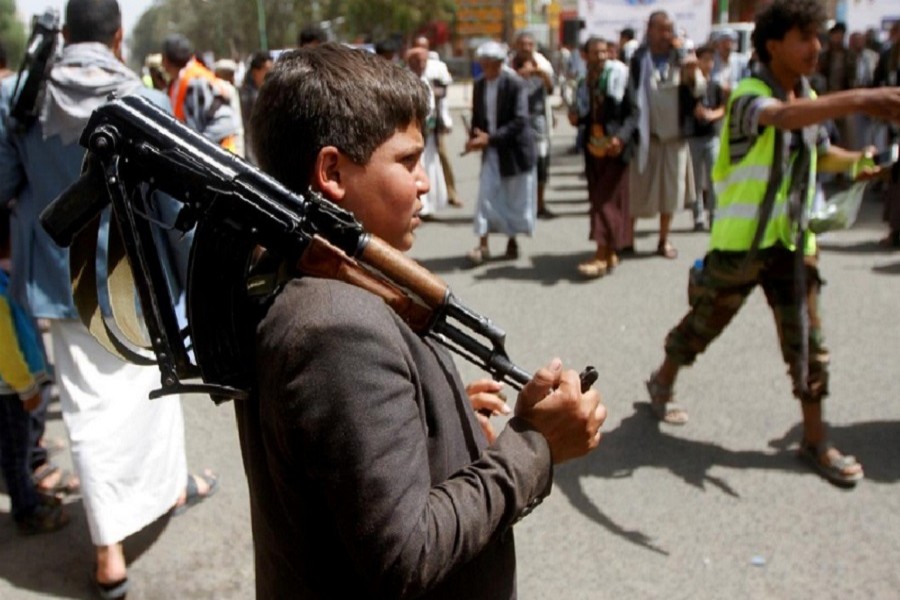 A boy carries a weapon as he and Houthi supporters are seen during a gathering in Sanaa, Yemen, April 02, 2020. — Reuters/Files