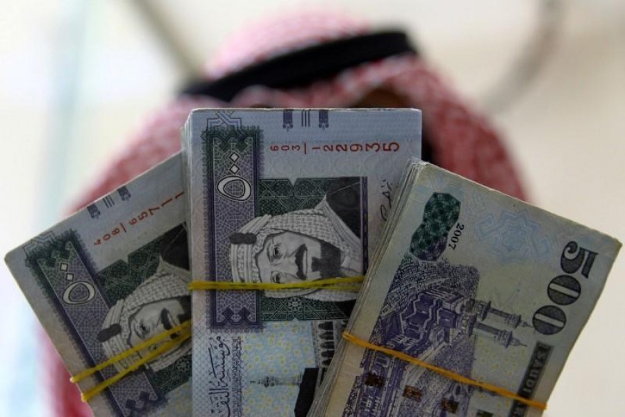 A Saudi money changer displays Saudi Riyal banknotes at a currency exchange shop in Riyadh, Saudi Arabia September 29, 2016. REUTERS/Faisal Al Nasser/Files