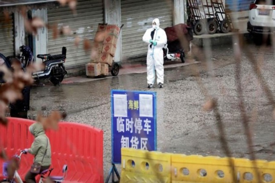 A worker in a protective suit is seen at the closed seafood market in Wuhan, Hubei province, China Jan 10, 2020. REUTERS