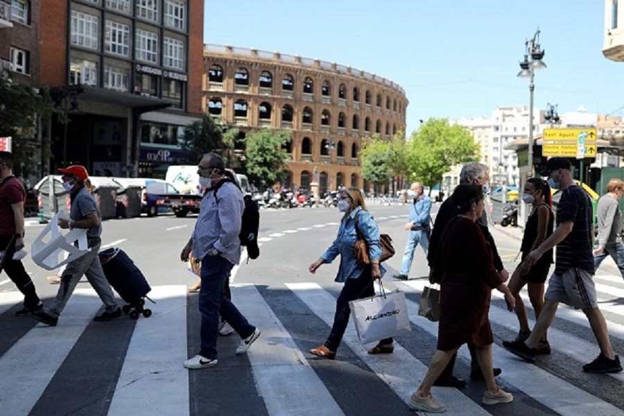 People wearing face masks walk on a crosswalk, as some Spanish provinces are allowed to ease lockdown restrictions during phase one, amid the coronavirus disease (Covid-19) outbreak, in Valencia, Spain May 19, 2020 — Reuters/Files