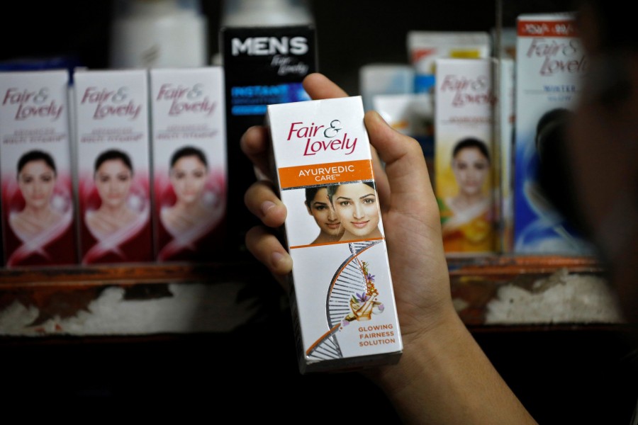 A customer picks up "Fair & Lovely" brand of skin lightening product from a shelf in a shop in Ahmedabad, India on June 25, 2020 — Reuters/Files