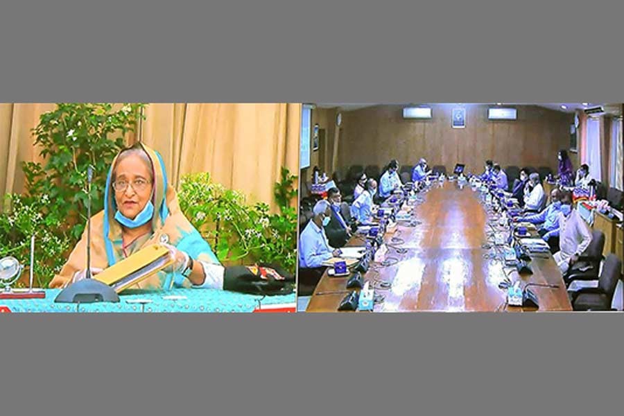 Prime Minister Sheikh Hasina presiding over the cabinet meeting through a videoconference Ganabhaban, while ministers and secretaries attended the meeting from the Bangladesh Secretariat in Dhaka on Monday –BSS photo