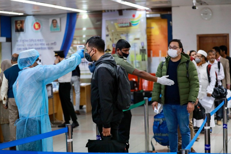 Passengers are checked with thermal scanner at the Hazrat Shahjalal International Airport as a preventive measure against coronavirus in Dhaka on 11 March, 2020 — Reuters/Files