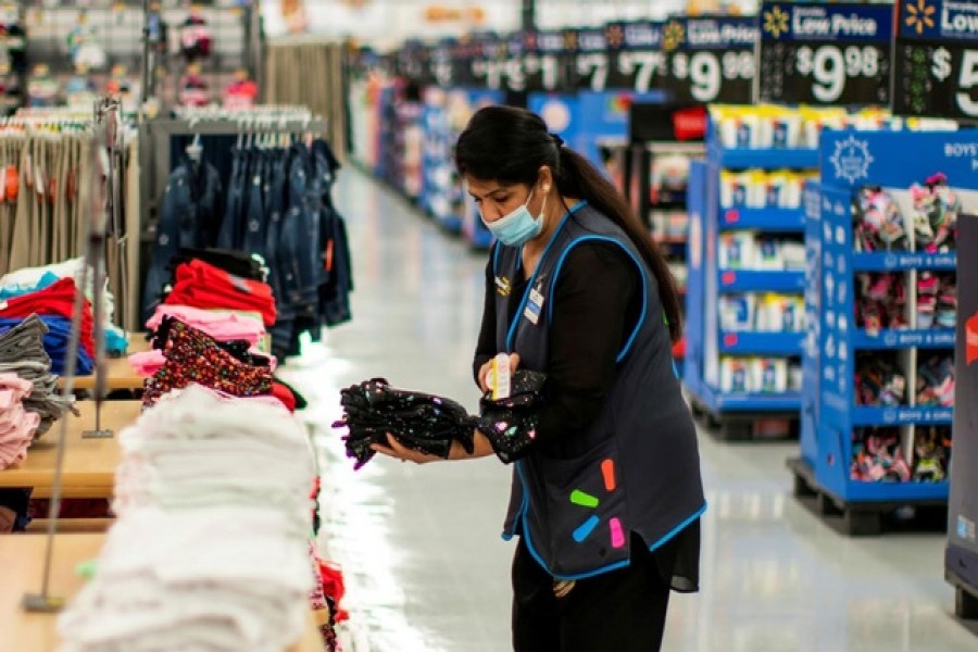 A worker is seen wearing a mask while organising merchandise at a Walmart store, in North Brunswick, New Jersey, US, July 20, 2020 — Reuters
