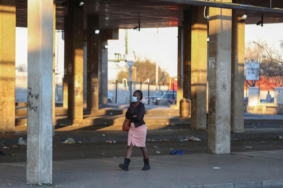 FILE PHOTO: A Stranded commuter walks at a deserted Baragwanath taxi rank during a protest by the South African minibus taxi operators against the government's financial relief package to the taxi industry, during the coronavirus disease (COVID-19) lockdown, in Soweto, South Africa, June 22, 2020. REUTERS/Siphiwe Sibeko