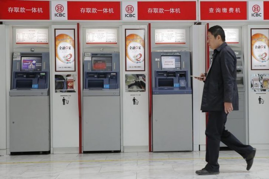 A man walks past the ATMs of Industrial and Commercial Bank of China Ltd (ICBC) in Beijing — reuters/Files
