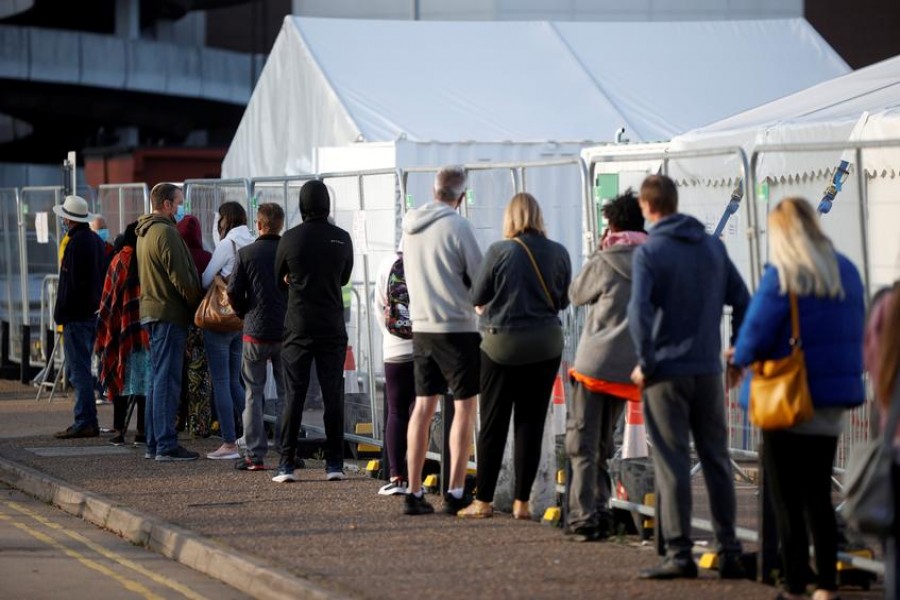FILE PHOTO: People queue outside a test centre, following an outbreak of the coronavirus disease (COVID-19), in Southend-on-sea, Britain September 17, 2020. REUTERS/John Sibley/File Photo