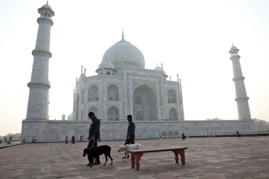 Police officers use sniffer dogs to scan the premises of the historic Taj Mahal, in Agra, India on February 24, 2020 — Reuters/Files
