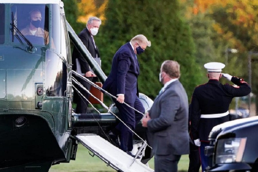 US President Donald Trump disembarks from the Marine One helicopter followed by White House Chief of Staff Mark Meadows as he arrives at Walter Reed National Military Medical Center after the White House announced that he "will be working from the presidential offices at Walter Reed for the next few days" after testing positive for the coronavirus disease (Covid-19), in Bethesda, Maryland, US, October 2, 2020 — Reuters