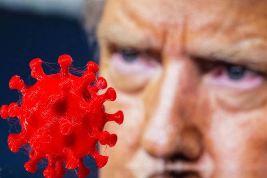 A 3D printed coronavirus model is seen in front of a displayed image of US President Donald Trump in this picture illustration taken October 3, 2020.