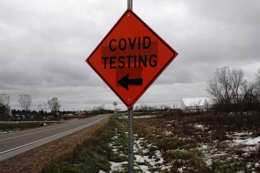 A sign for a Covid-19 drive-thru testing site alongside US Highway 12 is seen as the coronavirus disease (Covid-19) outbreak continues in Eau Claire, Wisconsin, US, October 23, 2020 -- Reuters