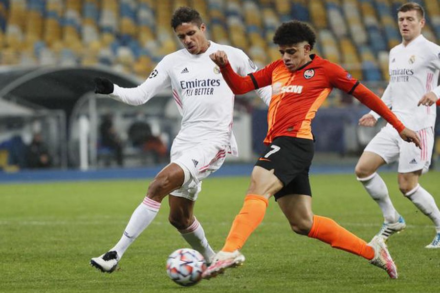Shakhtar Donetsk's Taison in action with Real Madrid's Raphael Varane during the clash on Tuesday — Reuters photo