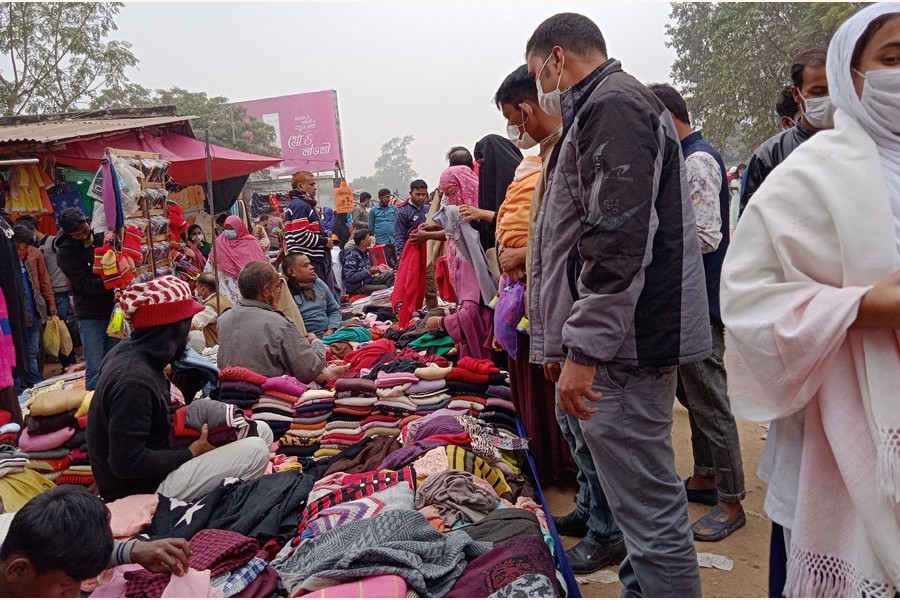 Buyers purchasing winter clothes at Hawker Market under sadarupazila in Bogura. The photo was taken on Thursday — FE Photo