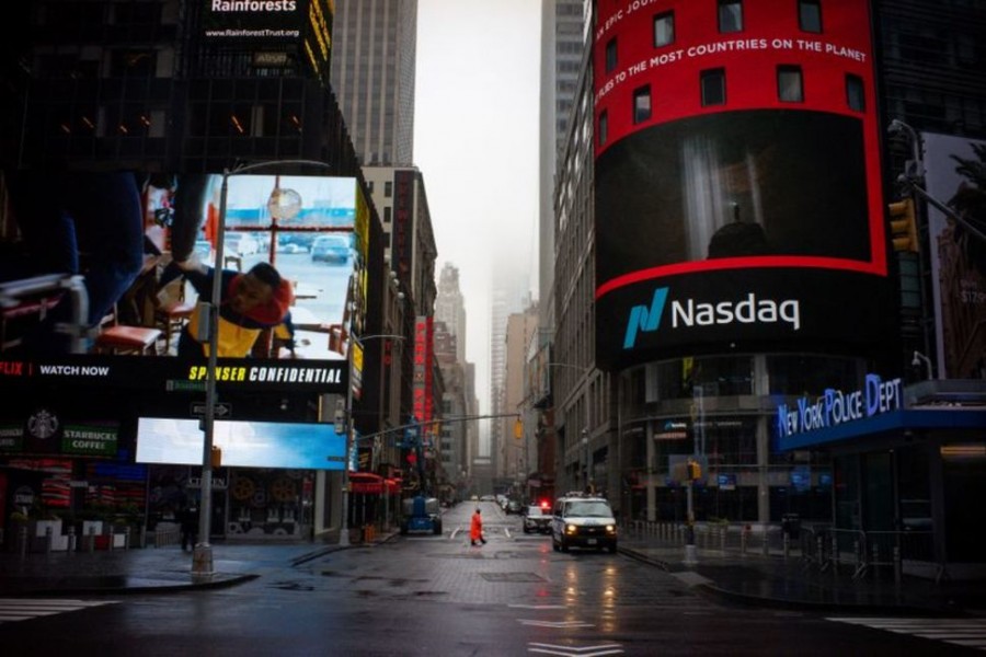A man walks near Nasdaq MarketSite in an empty Times Square as the coronavirus disease (COVID-19) outbreak continues in New York City, US, March 29, 2020. REUTERS/Eduardo Munoz