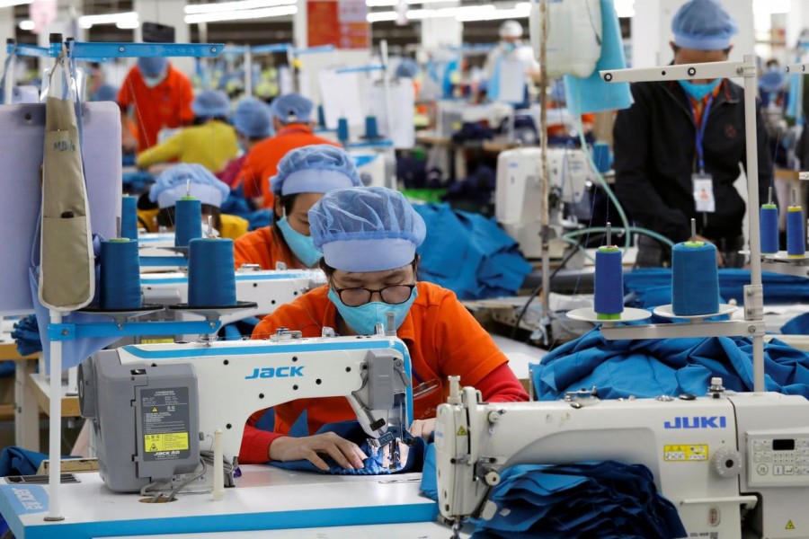 FILE PHOTO: Labourers work at Hung Viet garment export factory in Hung Yen province, Vietnam December 30, 2020. REUTERS/Kham/File Photo