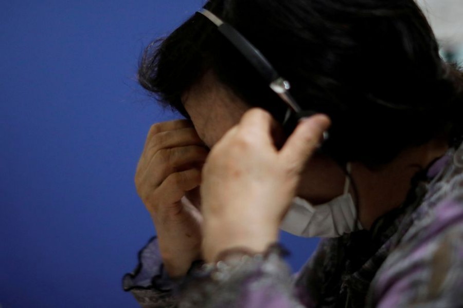A volunteer responds an incoming call at the Tokyo Befrienders call center, a Tokyo's suicide hotline center, during the spread of the coronavirus disease (COVID-19), in Tokyo, Japan May 26, 2020. REUTERS