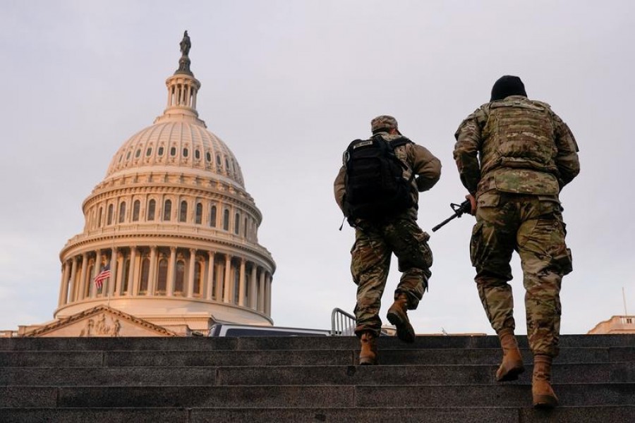 National Guard members walk at the Capitol, in Washington, US on January 15, 2021 — Reuters/Files