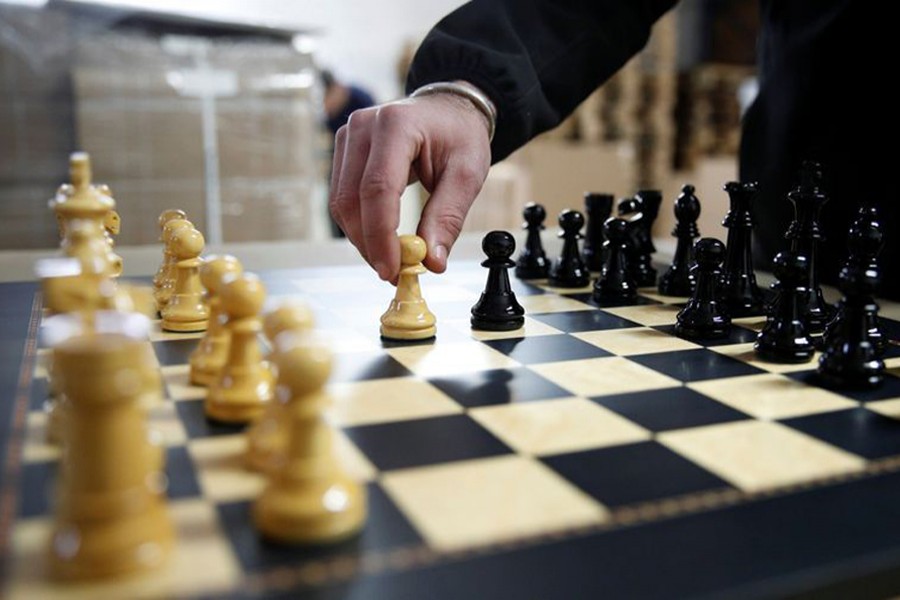 David Ferrer moves a chess pawn on a chessboard at the Rechapados Ferrer factory of which products have appeared in the Netflix series "The Queen's Gambit", in La Garriga, north of Barcelona, Spain on February 11, 2021 — Reuters photo