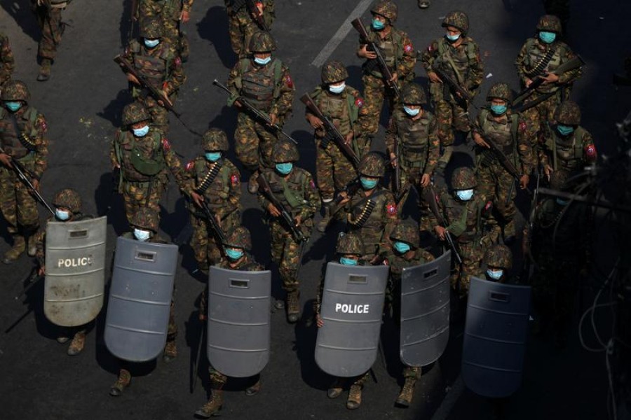 FILE PHOTO: Myanmar soldiers from the 77th light infantry division walk along a street during a protest against the military coup in Yangon, Myanmar, February 28, 2021. REUTERS/Stringer