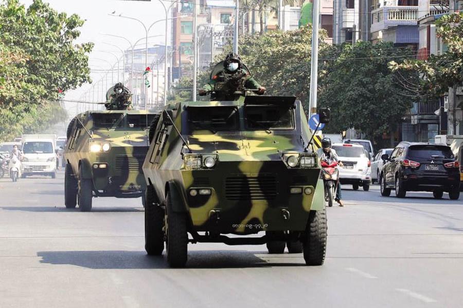 Myanmar army armoured vehicles drive in a street after the military seized power in a coup in Mandalay, Myanmar, February 3. 	—Reuters