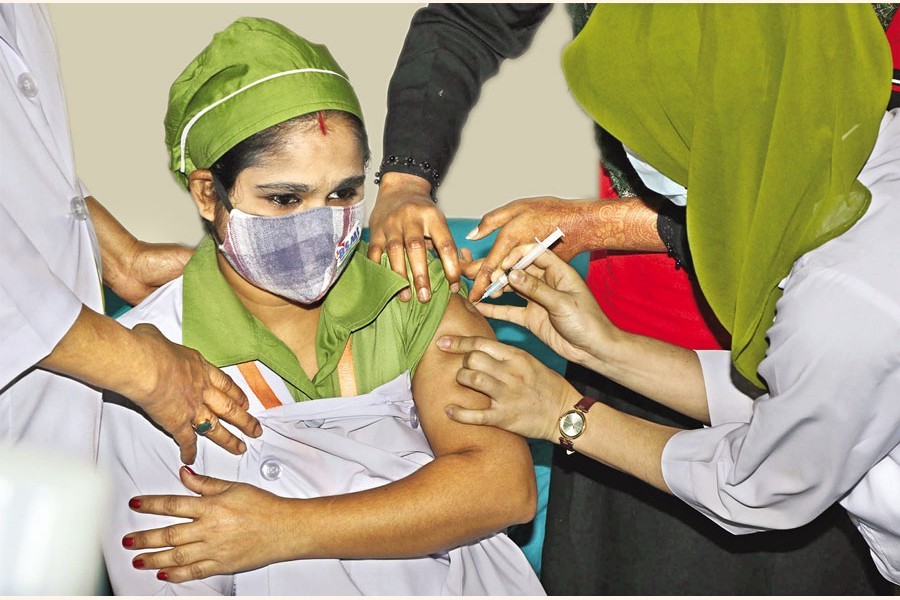 A health worker receives a Covid-19 vaccine at the Dhaka Medical College Hospital in the city as the nationwide vaccination drive started on Sunday, February 7, 2021 — FE Photo