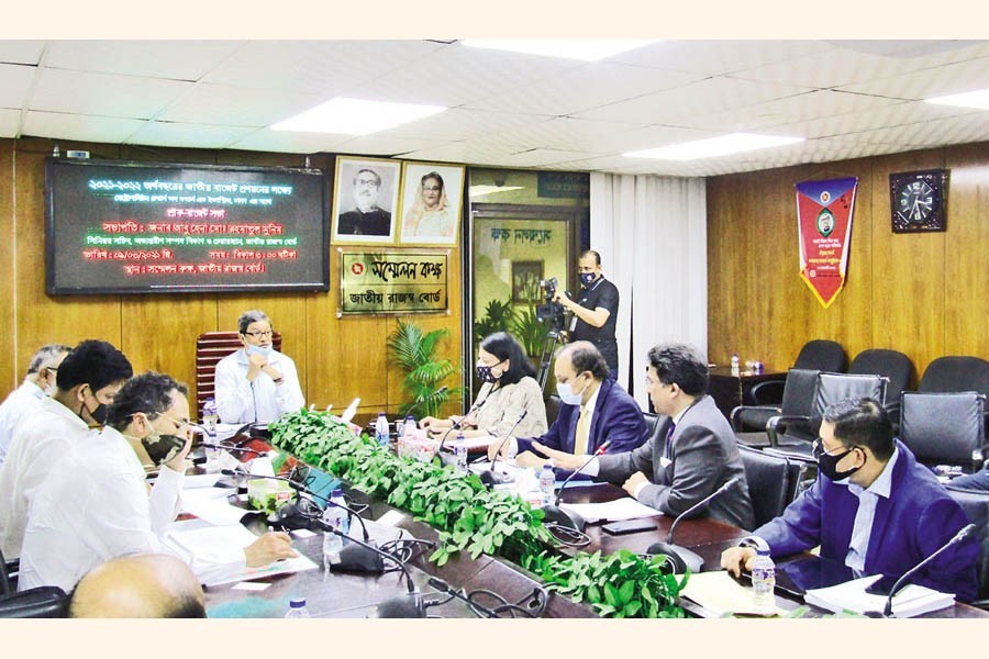 NBR Chairman Abu Hena Md Rahmatul Muneem presiding over a pre-budget meeting with a delegation of MCCI, Dhaka led by its President Nihad Kabir at the conference room of the NBR in the city on Tuesday