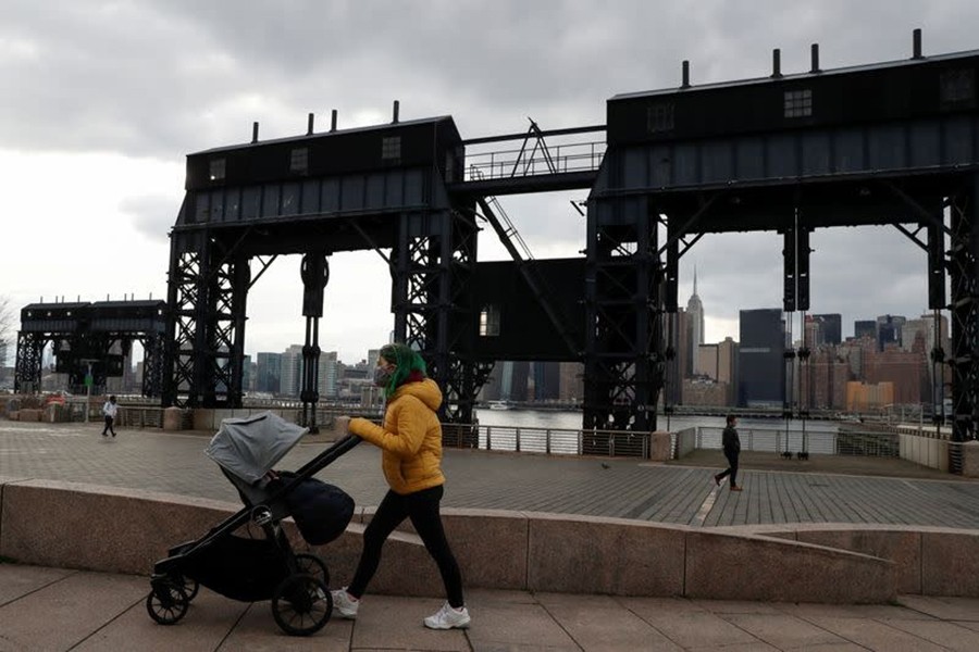 A woman wearing a protective face mask pushes a baby stroller, amid the spread of the coronavirus disease (Covid-19), at Gentry Plaza State Park in the Queens borough of New York, US on, March 1, 2021 — Reuters/Files