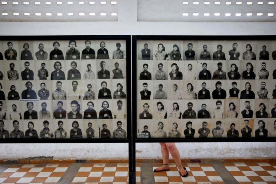 A visitor looks at pictures of victims of Khmer Rouge regime at the former notorious Tuol Sleng prison that is now the Genocide Museum, in Phnom Penh August 5, 2014. REUTERS/Damir Sagol