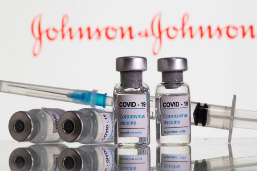 Vials labelled "COVID-19 Coronavirus Vaccine" and syringe are seen in front of displayed Johnson&Johnson logo in this illustration taken, February 9, 2021. Reuters